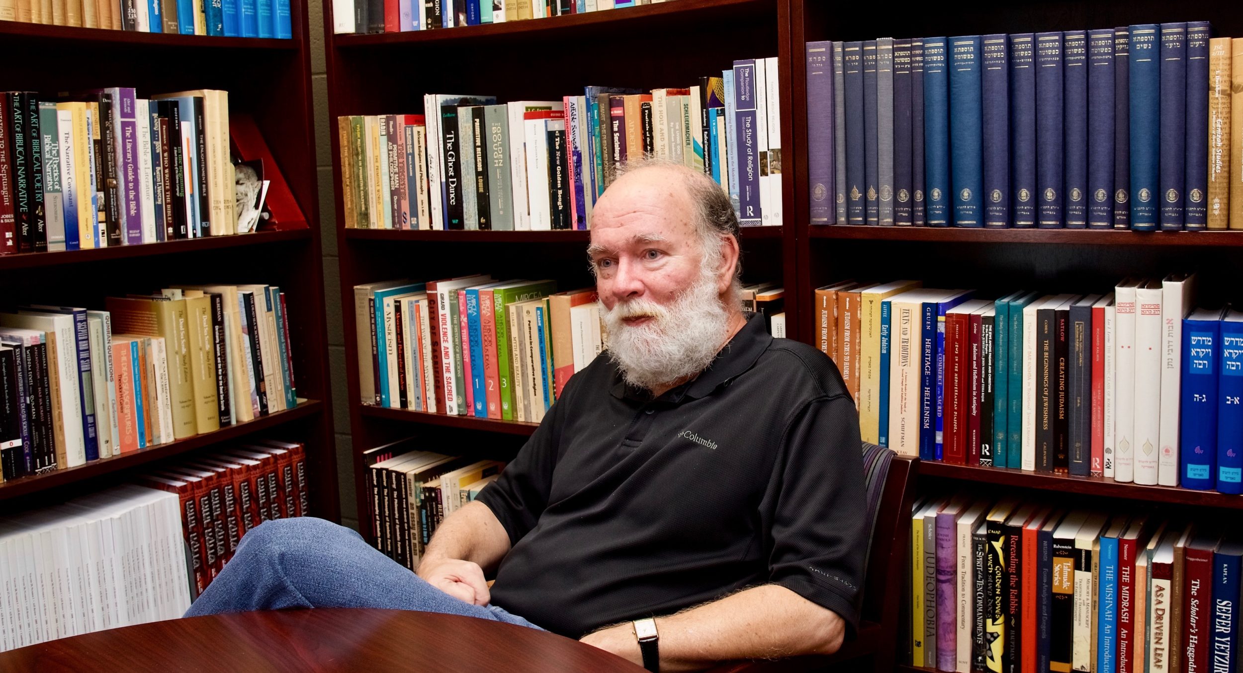 Reeves in his office with books