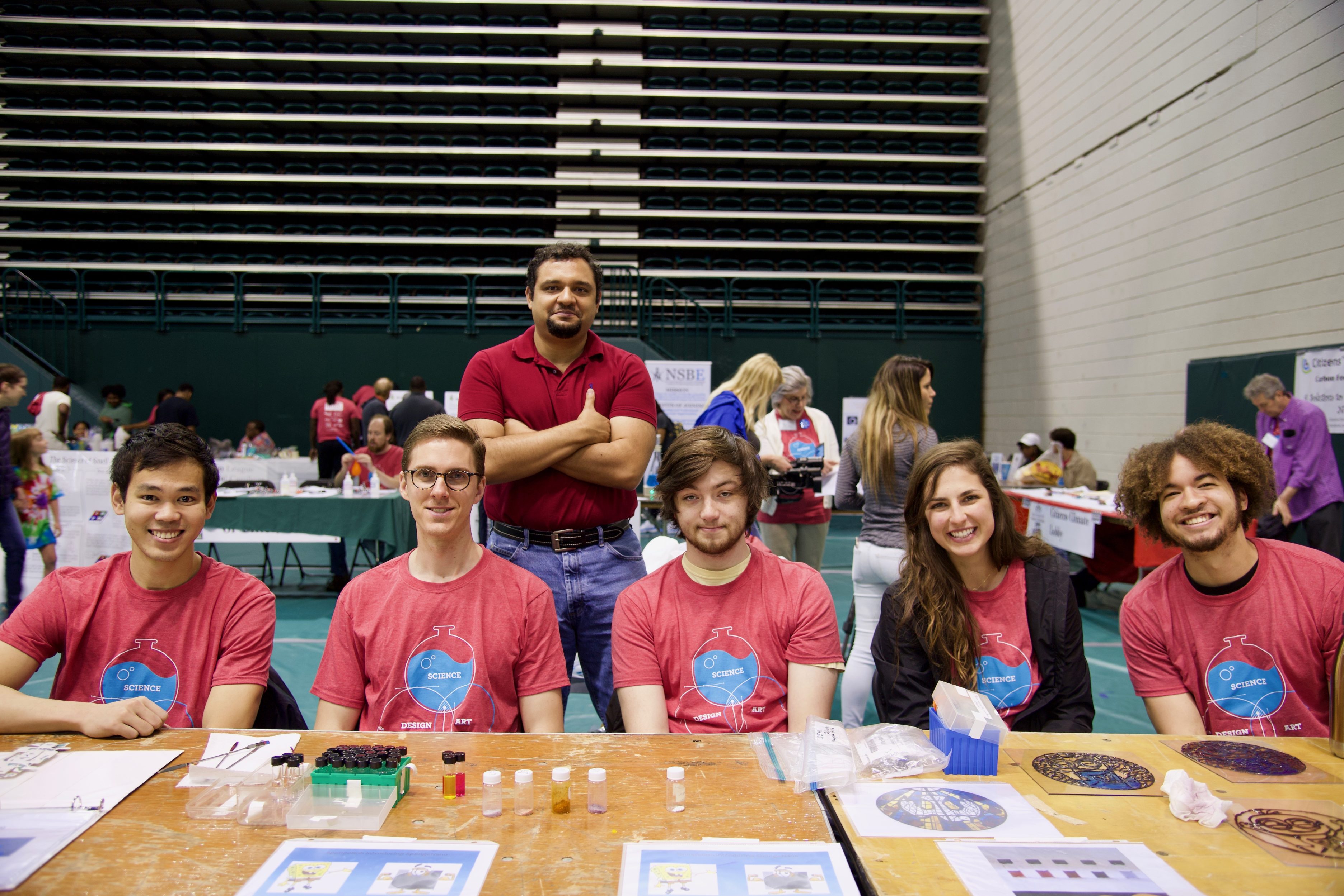 Juan Luis Vivero-Escoto (standing) and his students volunteer at the UNC Charlotte Science and Technology Expo.
